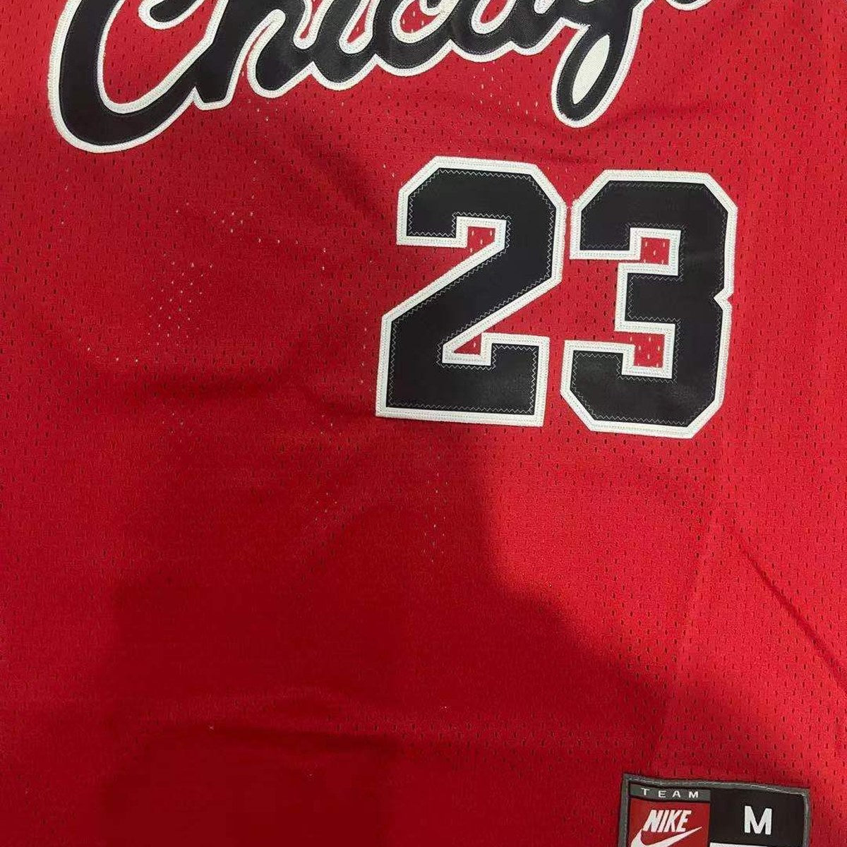 Chicago Bulls #23 Basketball Jersey – Red, Retro, Chicago Lettering and Black Jock Tag (close-up of the fabric and print)